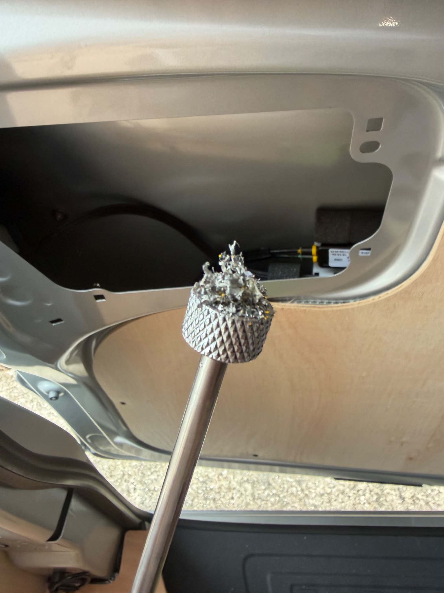 Magnet lifting metal swarf out of the door internals during a van security fit in Beverley